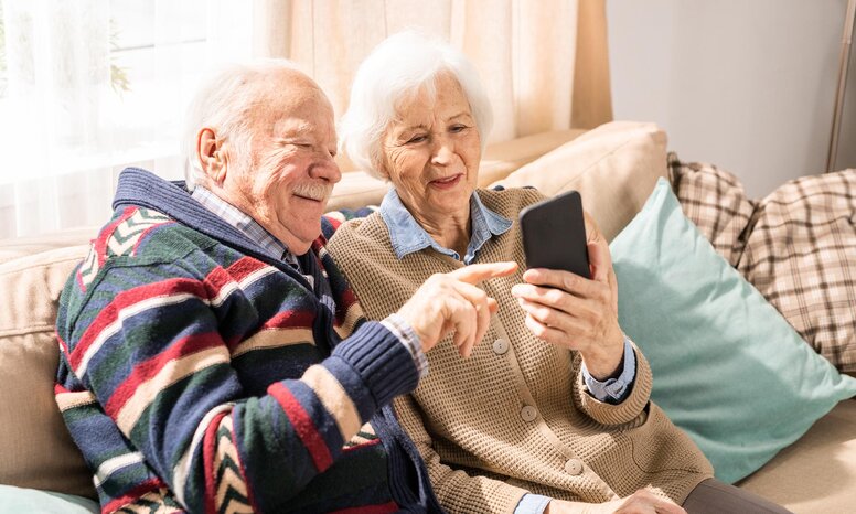 Bild eines älteren Paares, das zusammen ein Smartphone nutzt